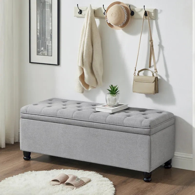Banc de rangement capitonné en tissu de lin avec pieds fuselés en bois