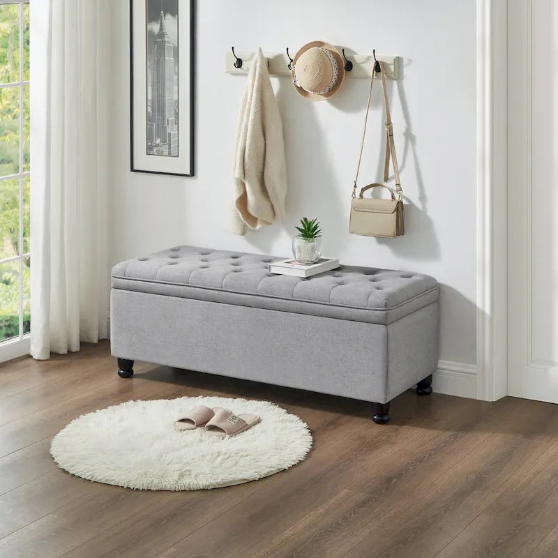 Banc de rangement capitonné en tissu de lin avec pieds fuselés en bois