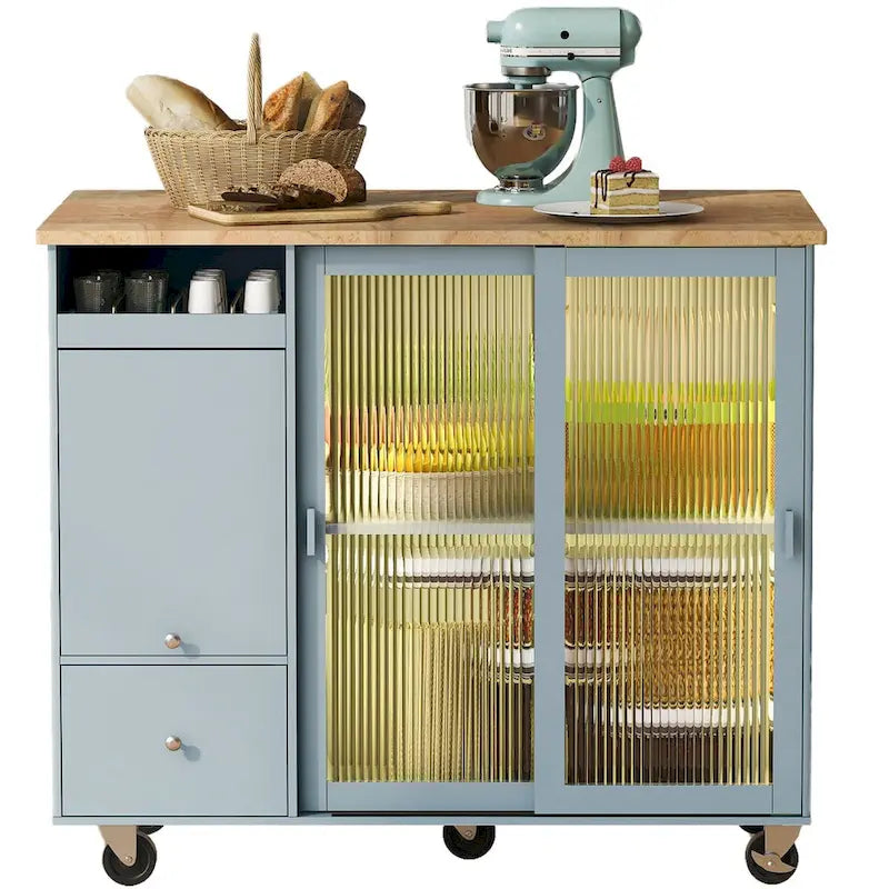 Îlot de cuisine avec surface à rabat, éclairage LED, portes en verre cannelé, étagère réglable, deux tiroirs et roulettes.